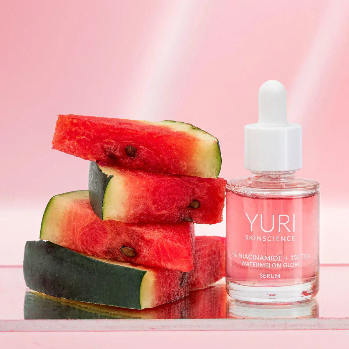 Yuri Skinscience Watermelon Glow Serum next to watermelon slices