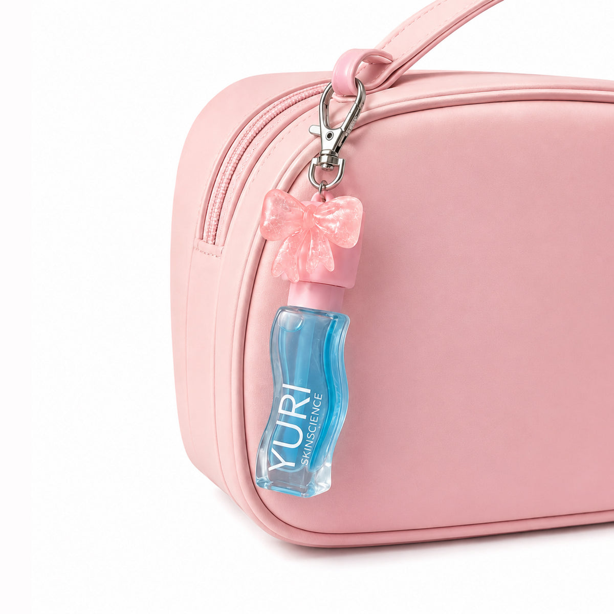 yuri Skinscience pH activated Lip Oil Bag charm . Demonastration of bag charm hanging on the bag with lip oil
