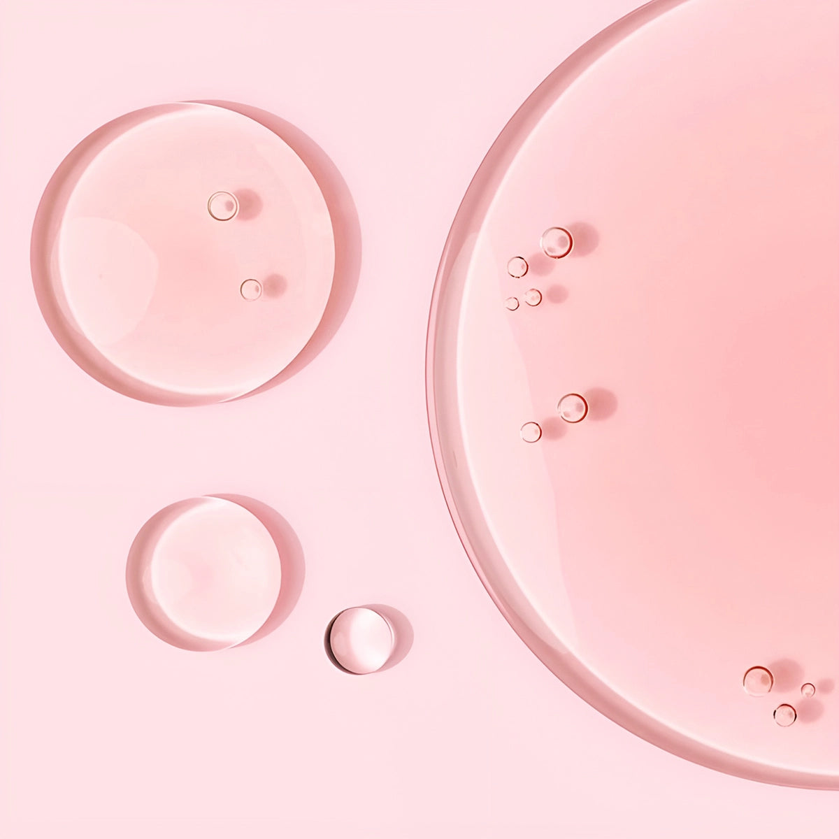 Skincare drops on a pink background